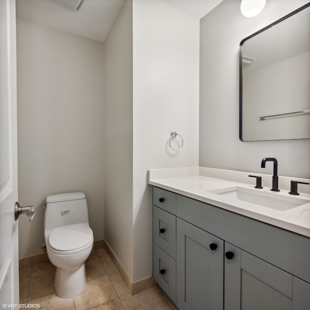 3404 North Seminary Avenue, Unit 1 Chicago, IL 60657 - Photo 6 of 15 a bathroom with a toilet sink and mirror