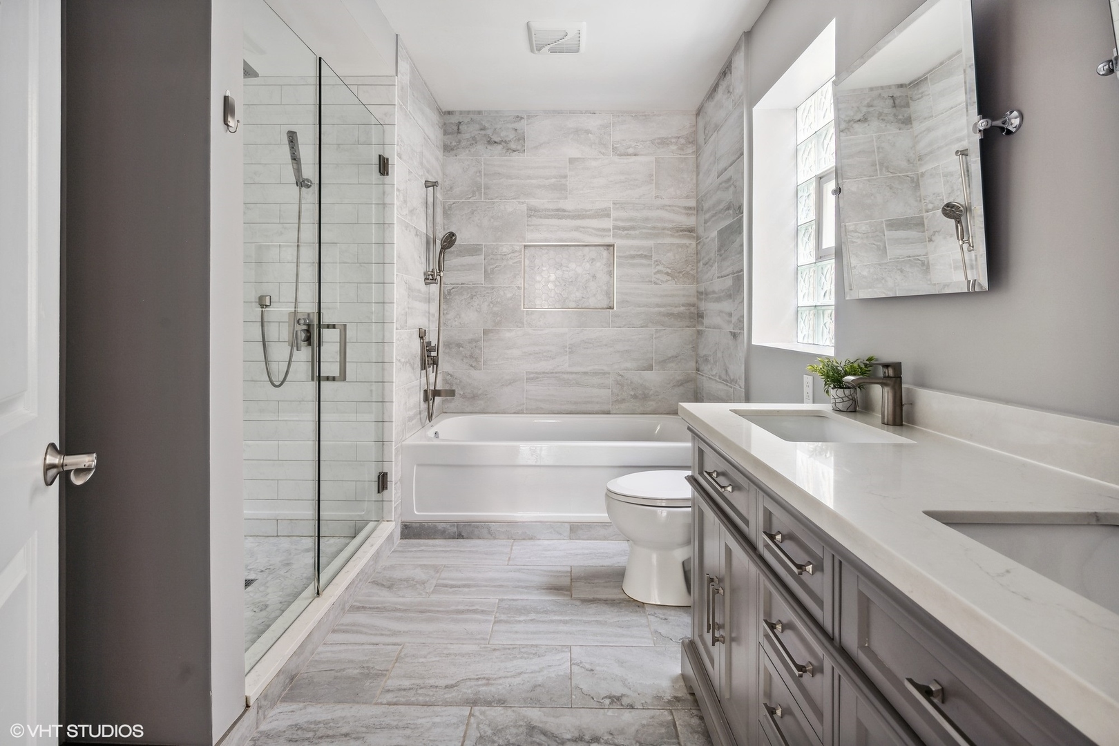 3404 North Seminary Avenue, Unit 1 Chicago, IL 60657 - Photo 8 of 15 a bathroom with a granite countertop sink a toilet and shower