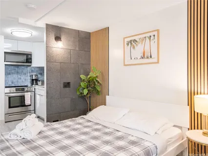 a bedroom with a bed potted plant and a window