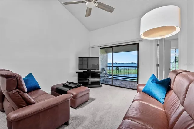 a living room with furniture a rug and white walls
