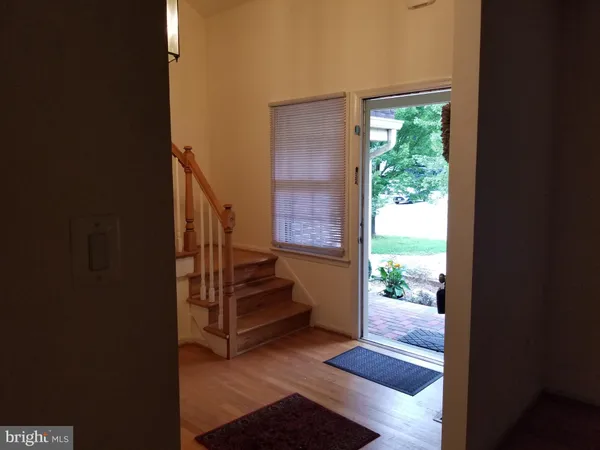 a view of an entryway with wooden floor and a floor to ceiling window