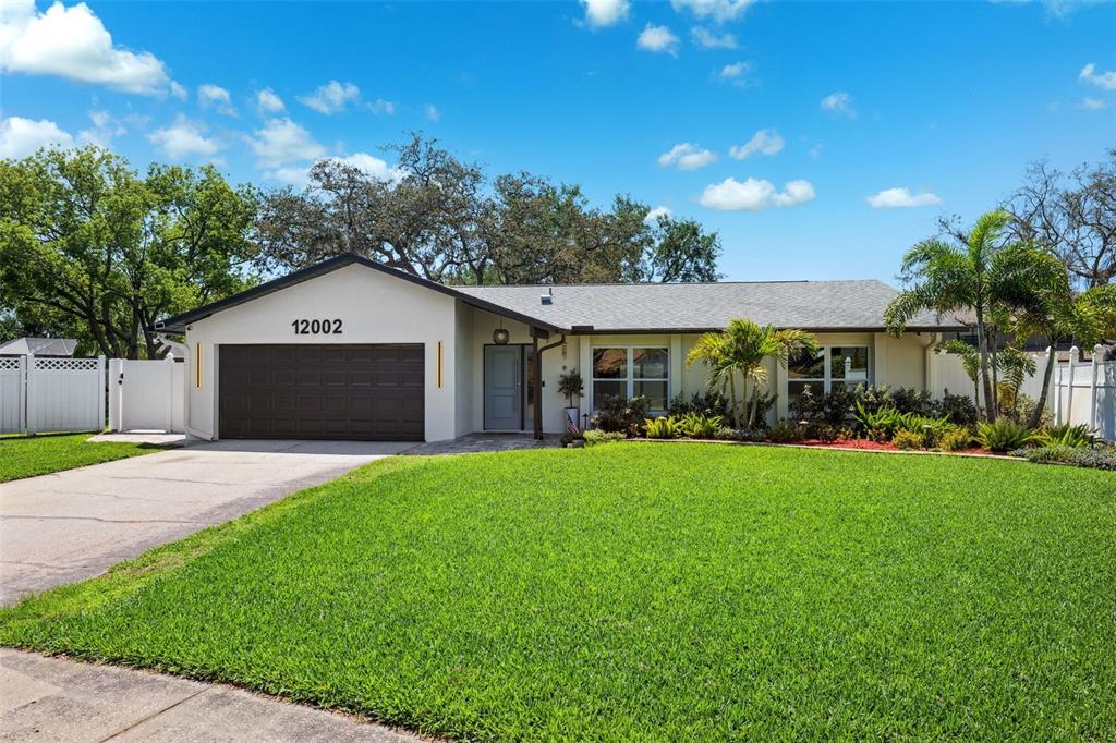 a front view of a house with a yard and garage