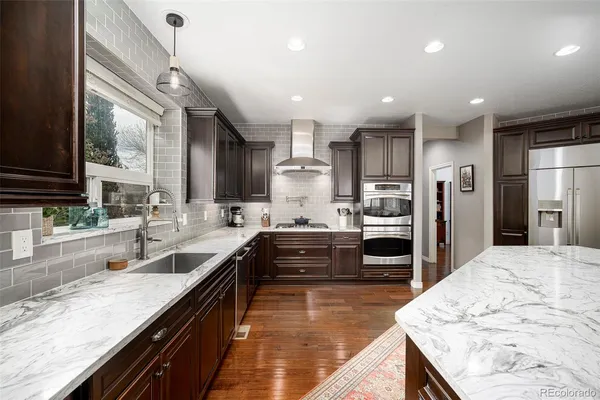 a large kitchen with stainless steel appliances kitchen island granite countertop a large counter top and stove