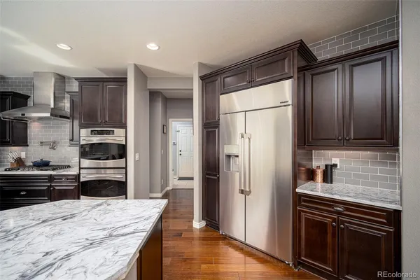 a kitchen with granite countertop stainless steel appliances and wooden cabinets