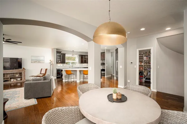 a living room with furniture a flat screen tv and kitchen view
