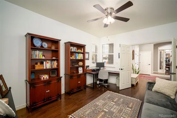 a view of a livingroom with workspace and a window