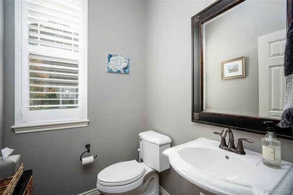 a bathroom with a sink a mirror and a toilet