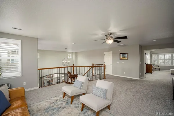 a view of livingroom with furniture and ceiling fan