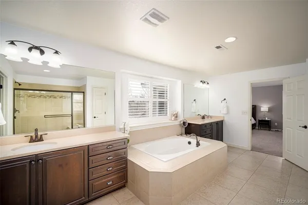 a bathroom with a sink a large mirror and a bathtub