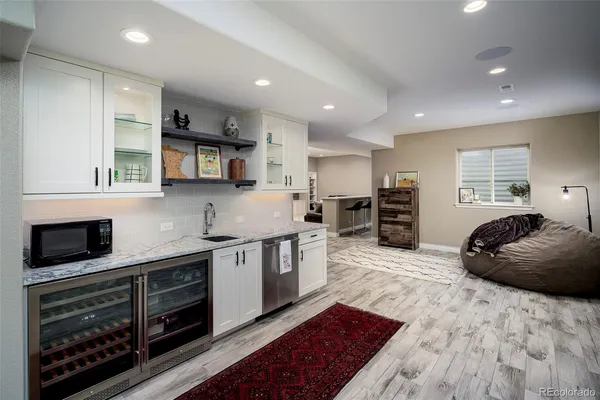 a kitchen with stainless steel appliances kitchen island granite countertop a stove a sink and a microwave