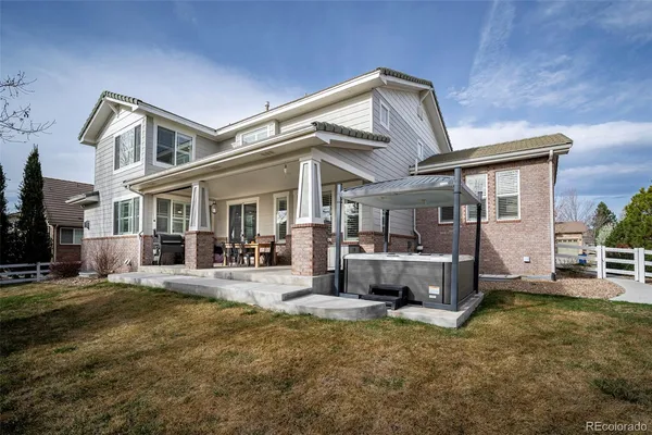 a view of a house with backyard and porch