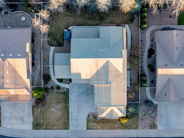 an aerial view of a house with a yard