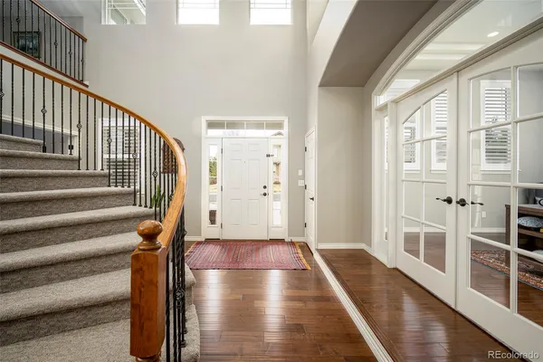 a view of an entryway with wooden floor and door