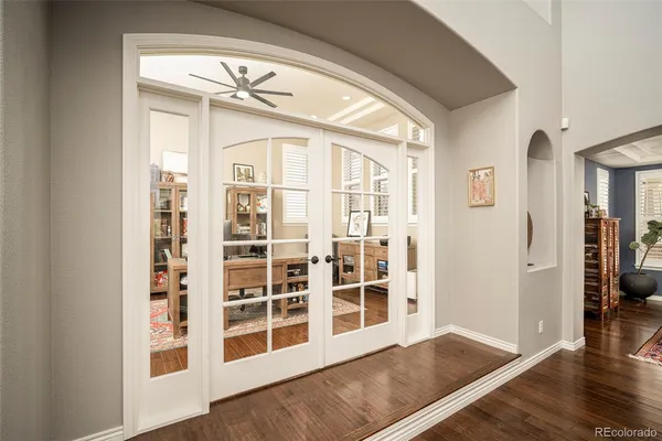 a view of an entryway with wooden floor and windows