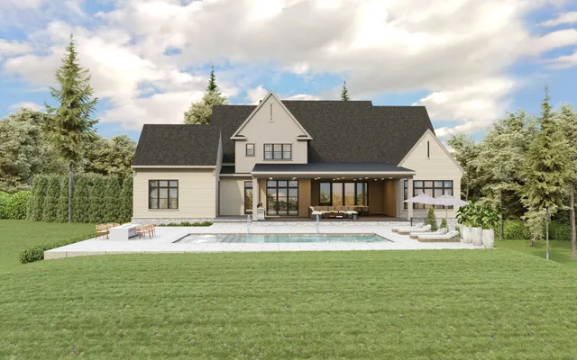 a front view of house with yard and trees in the background