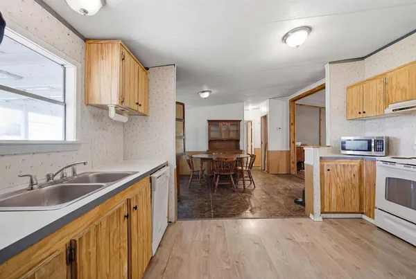 a kitchen with sink cabinets and wooden floor