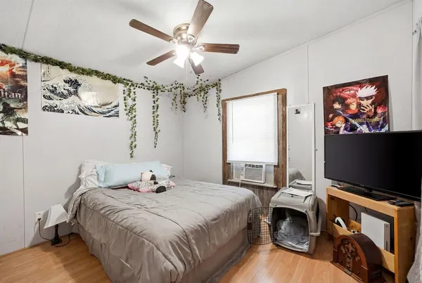 a bedroom with a bed and a flat screen tv