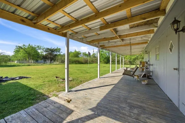a view of a backyard with wooden floor and roof