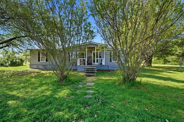 a view of a house with a backyard
