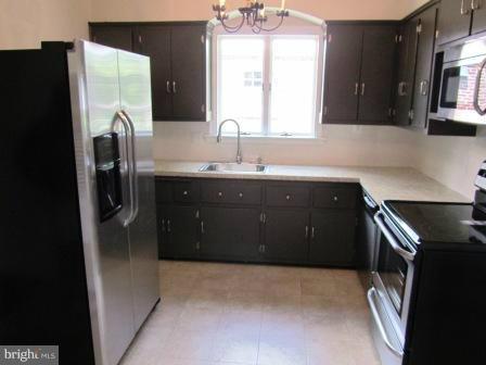 3009 Dunran Road Dundalk, MD 21222 - Photo 20 of 26 a kitchen with a sink and a refrigerator