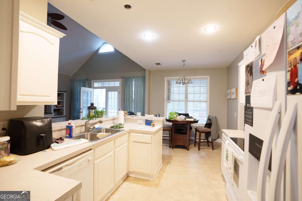 83 Gabriel Lane Baxley, GA 31513 - Photo 11 of 25 a kitchen with a sink stove and cabinets