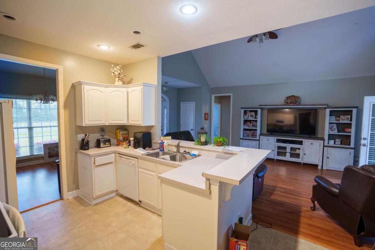 83 Gabriel Lane Baxley, GA 31513 - Photo 12 of 25 a open kitchen with cabinets a sink and a stove