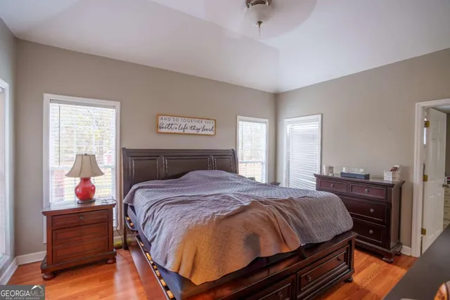 a bedroom with a bed and wooden floor