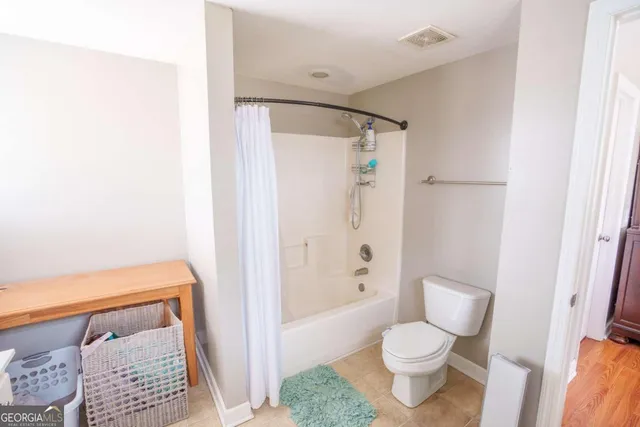 a bathroom with a toilet and a shower