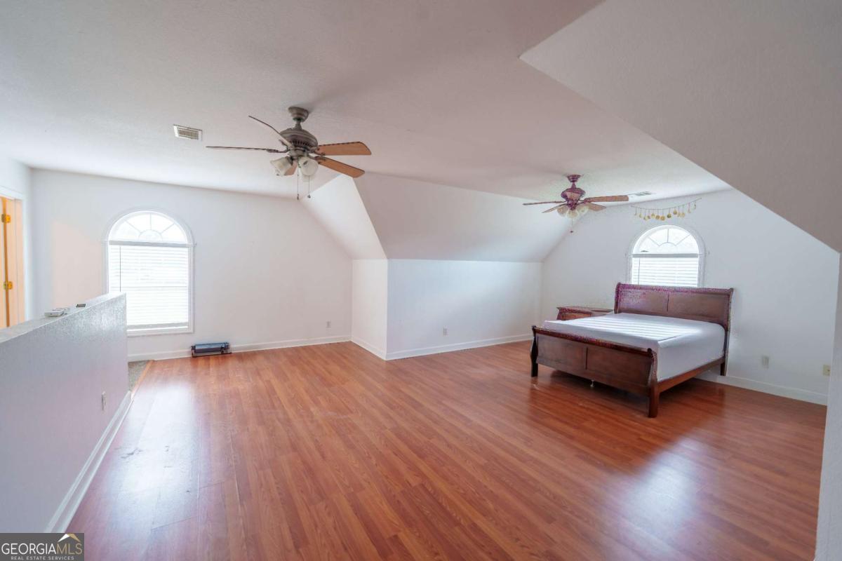 83 Gabriel Lane Baxley, GA 31513 - Photo 23 of 25 a bedroom with a bed and wooden floor