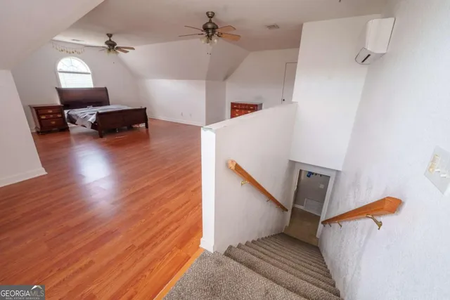 a view of a livingroom with furniture and a ceiling fan