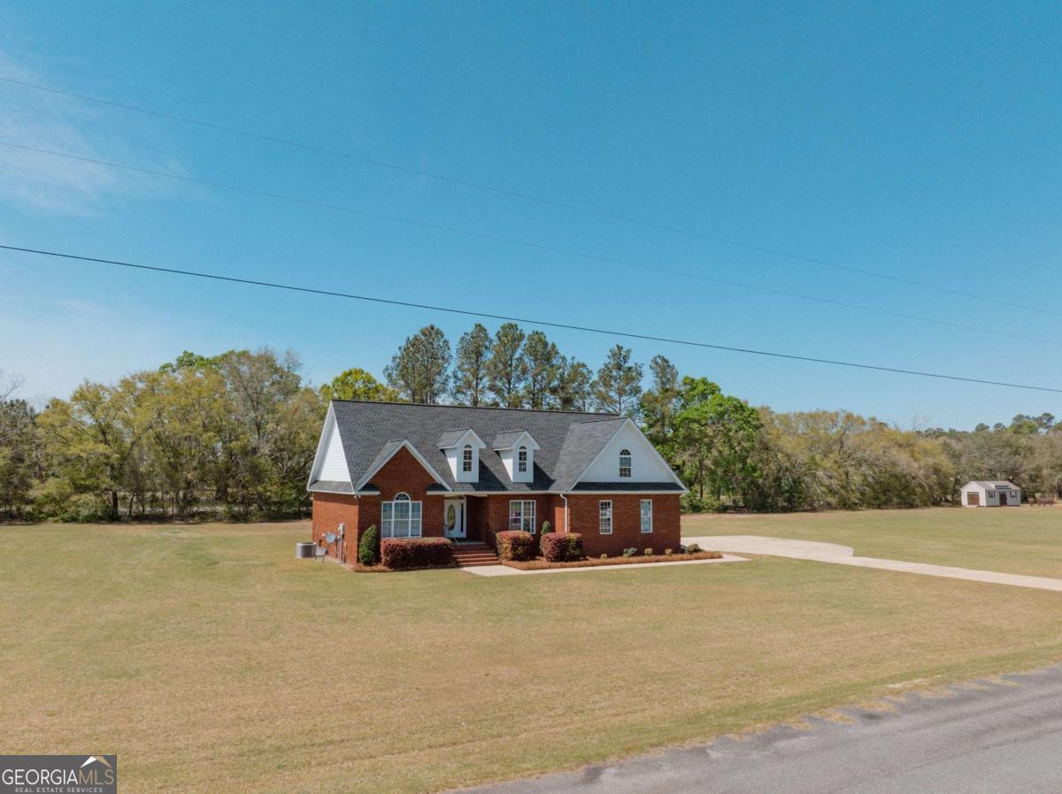 83 Gabriel Lane Baxley, GA 31513 - Photo 4 of 25 a outdoor space with a large building and trees in the background