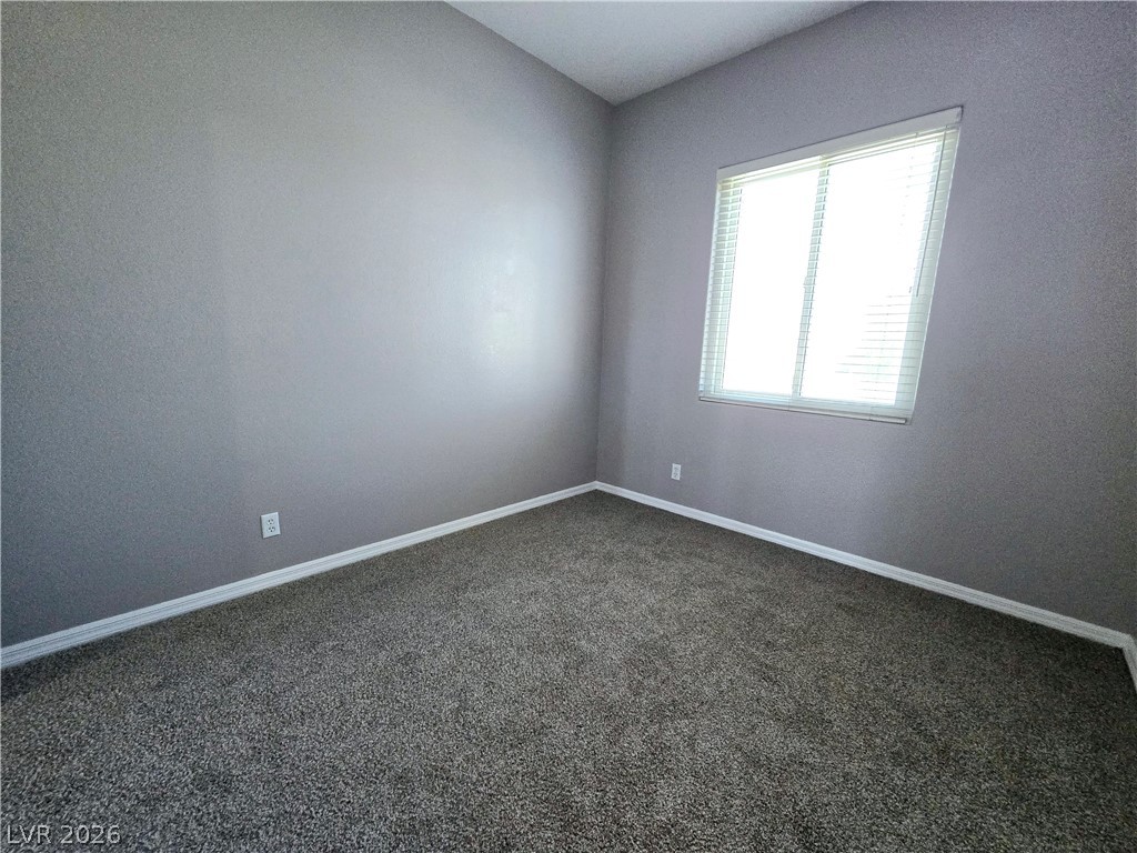 3759 Funston Way Las Vegas, NV 89129 - Photo 3 of 31 A well-lit bedroom awaits personalization with soft carpeting and a window dressed with blinds.