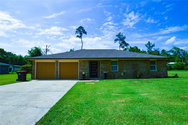 a front view of a house with yard and a garage