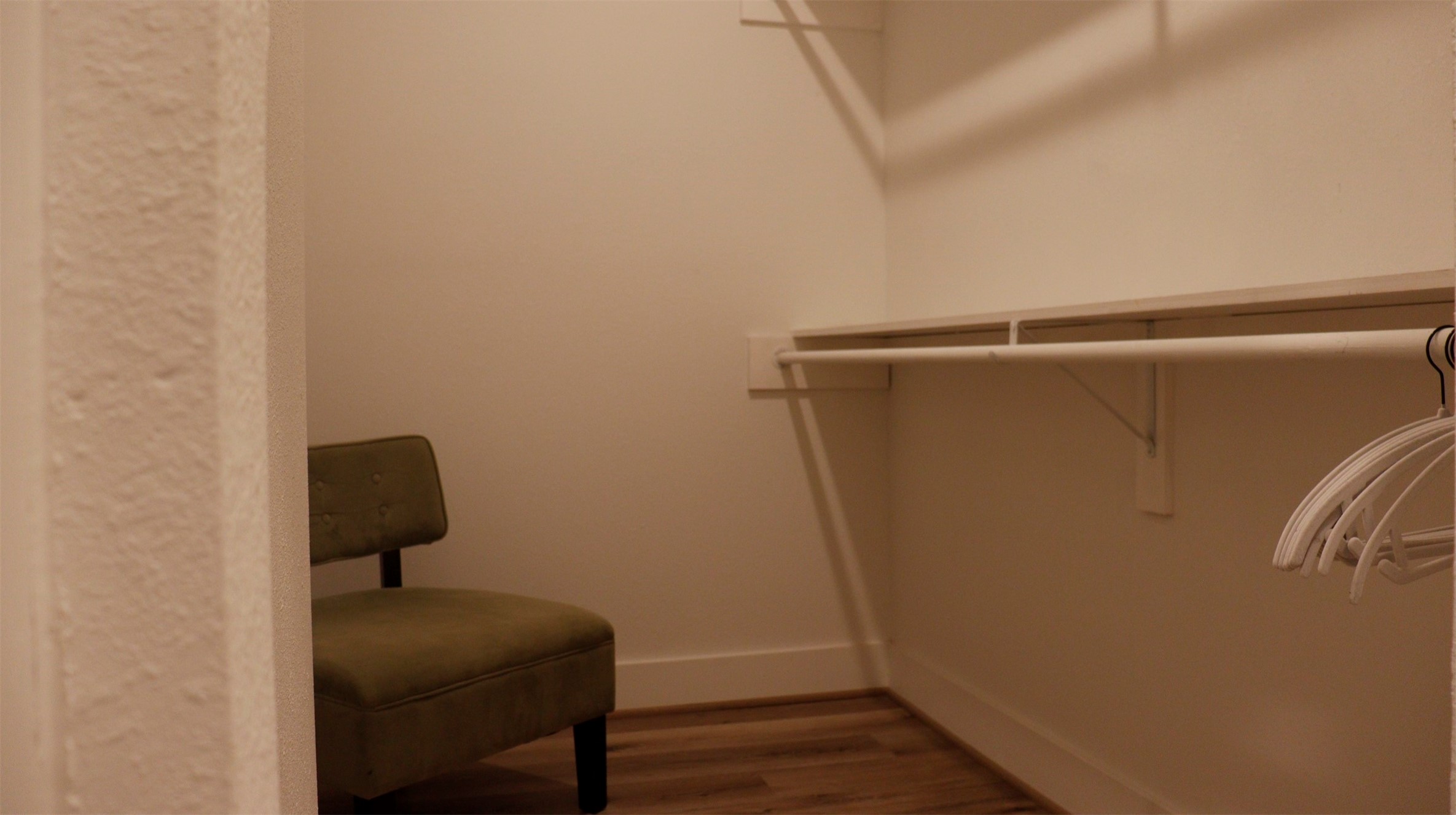 3824 Fulton Street, Unit 112 Houston, TX 77009 - Photo 15 of 15 a room with a chair and wooden floor