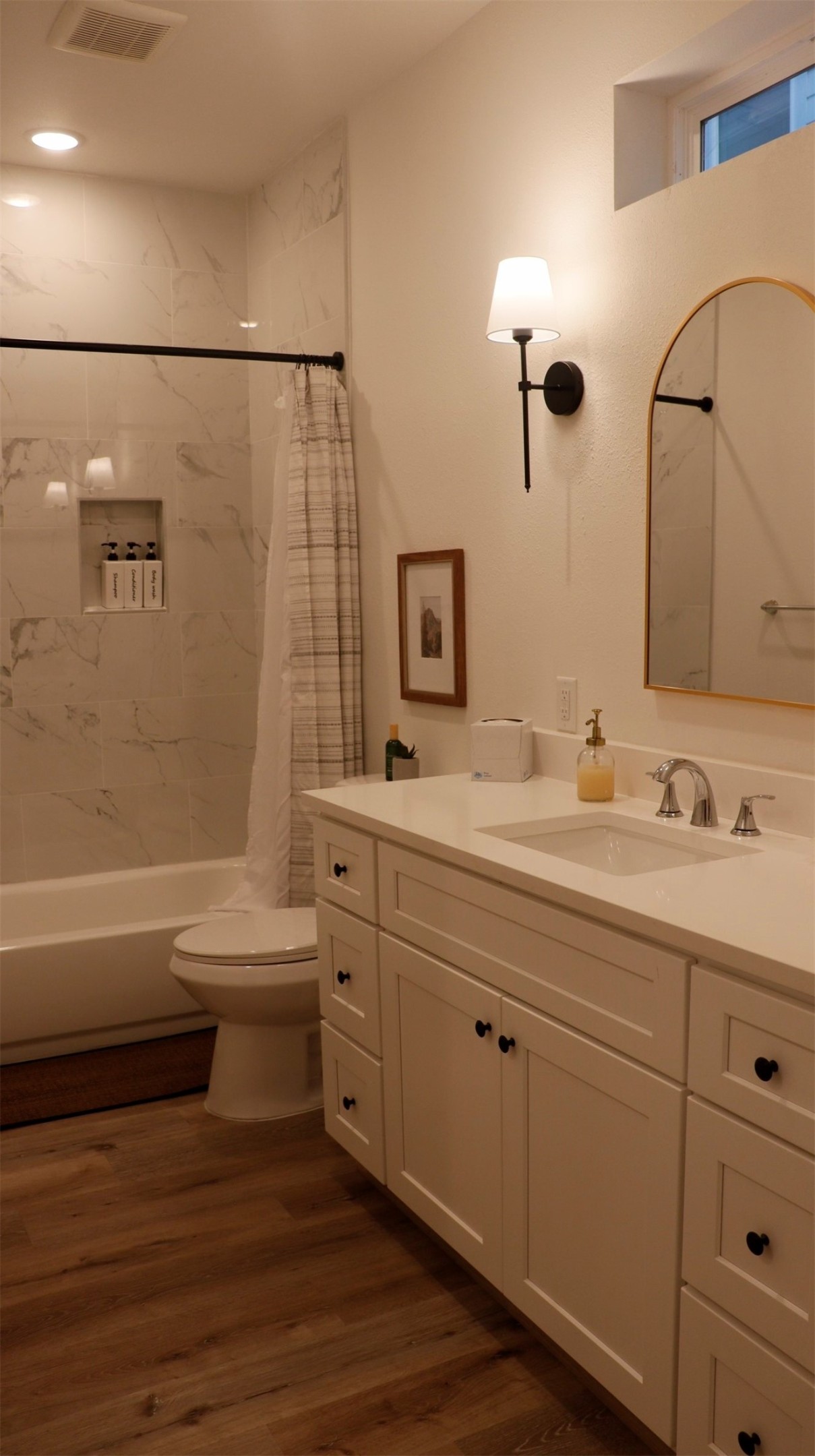 3824 Fulton Street, Unit 112 Houston, TX 77009 - Photo 9 of 15 a bathroom with a double vanity sink a toilet and a bathtub