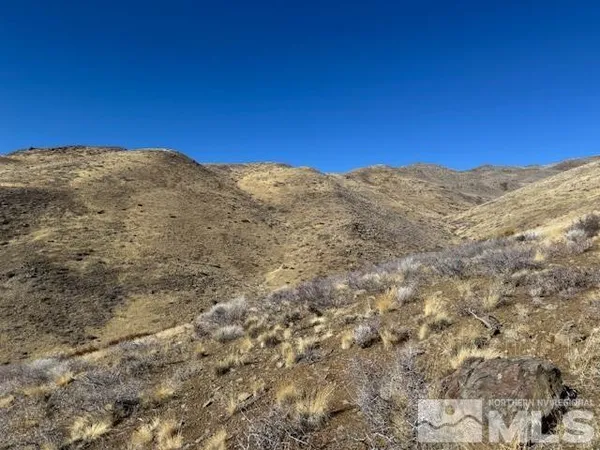 a view of a large mountain with mountains in the background