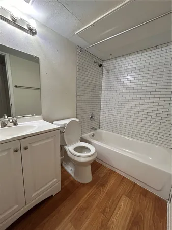 a bathroom with a toilet a sink and bathtub