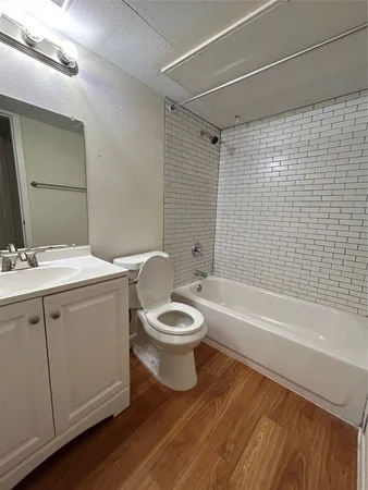 a bathroom with a toilet a sink and bathtub