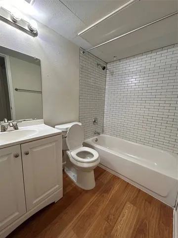 a bathroom with a toilet a sink and bathtub