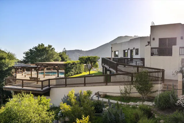 a view of a house with backyard porch and sitting area