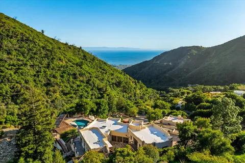 an aerial view of a house with a yard
