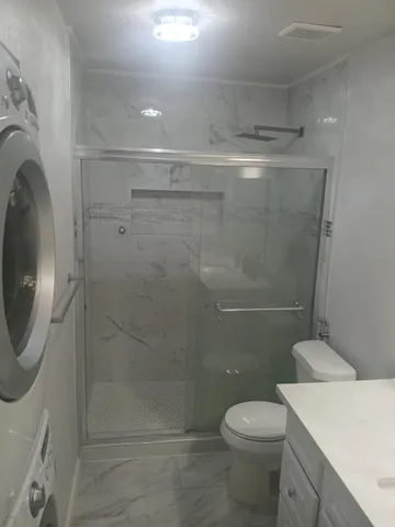 a bathroom with a toilet and a shower