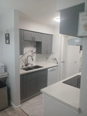 a kitchen with a sink a stove and refrigerator