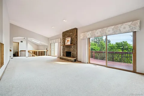a balcony with wooden floor and city view