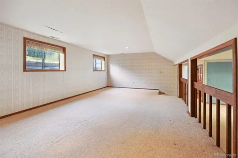 an empty room with a empty space and windows