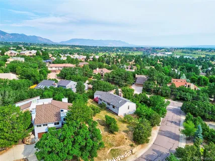 a view of a lush green hillside and houses