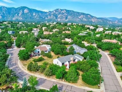 an aerial view of house with swimming pool and garden