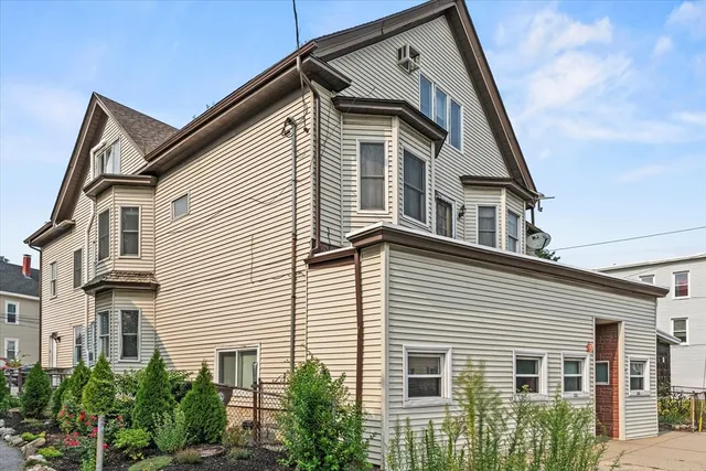 a view of a house with a small yard and plants