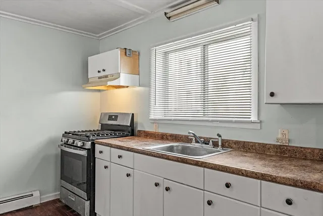 a kitchen with granite countertop a sink stainless steel appliances and cabinets