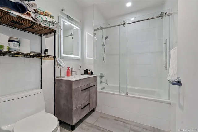 a bathroom with a shower toilet and sink